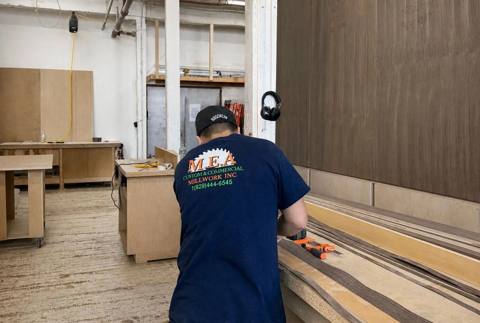 M.E.A. Millwork carpenter cutting panels in the shop